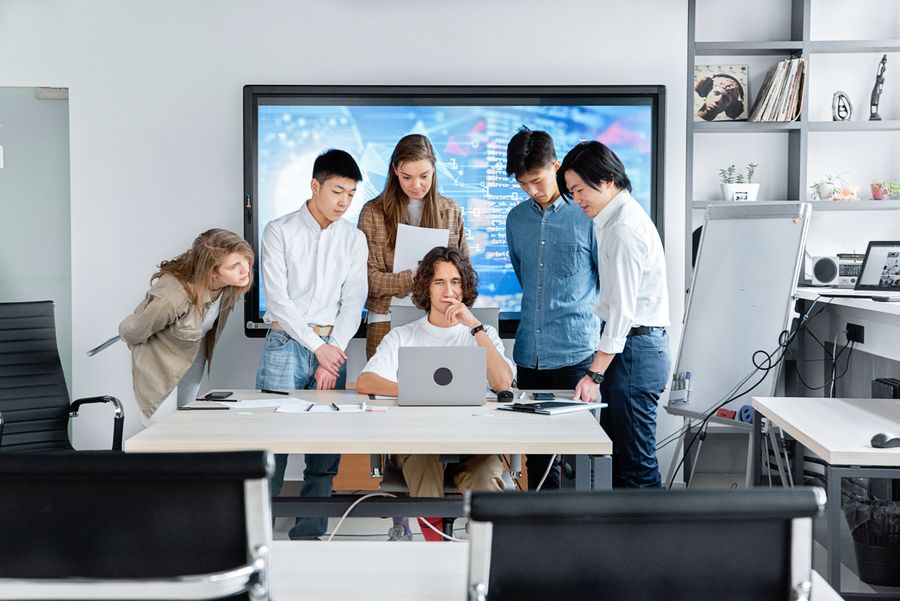 A diverse team collaborating on a software project in a contemporary office