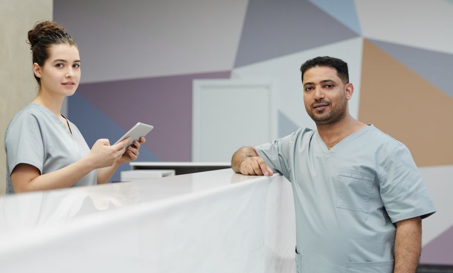 Clinic staff talking at a reception desk