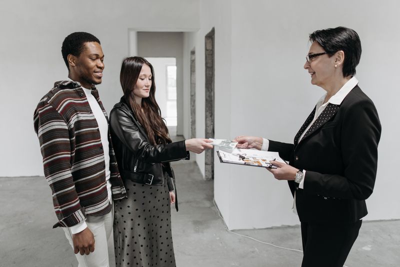 A couple reviews architectural plans with their buyer's agent during a consultation