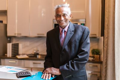 Portrait of a senior mortgage broker smiling in a modern office