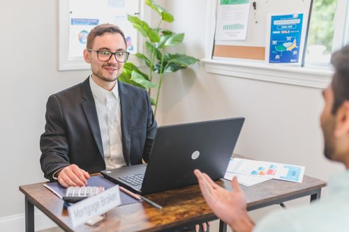 Broker and client reviewing home loan paperwork together