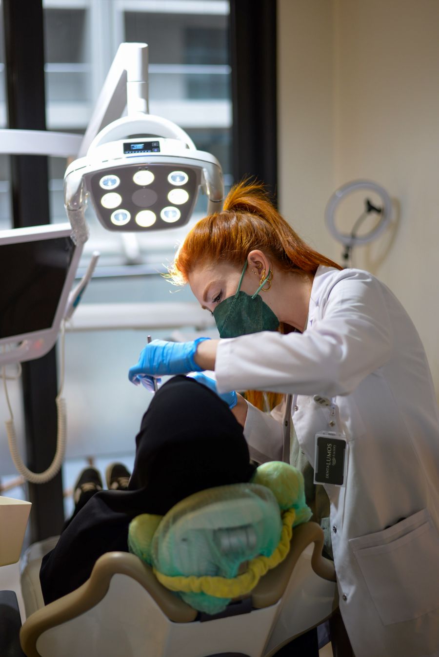A dentist carrying out a dental check-up on a patient in a bright, modern clinic