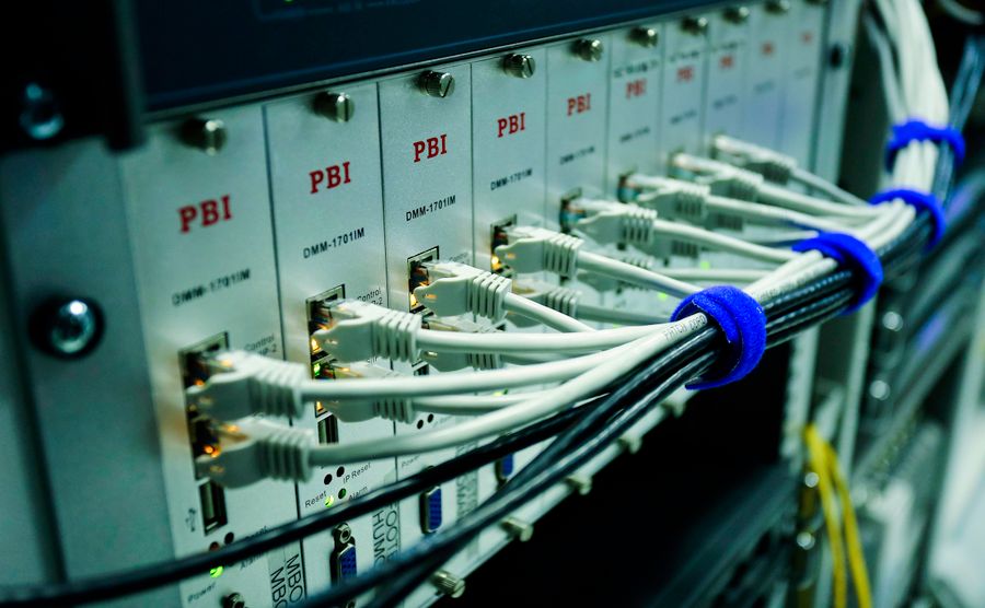 Close-up of ethernet cables connected to a network switch panel in a data centre
