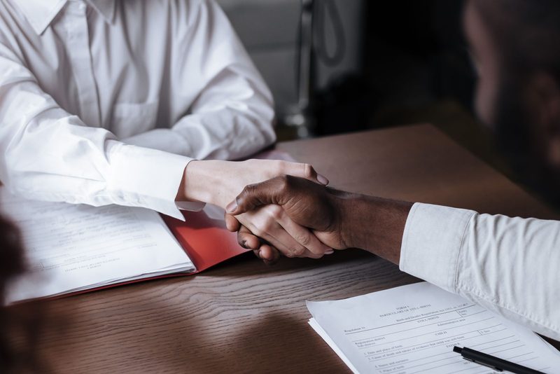 Advocate finalising a property purchase with clients indoors
