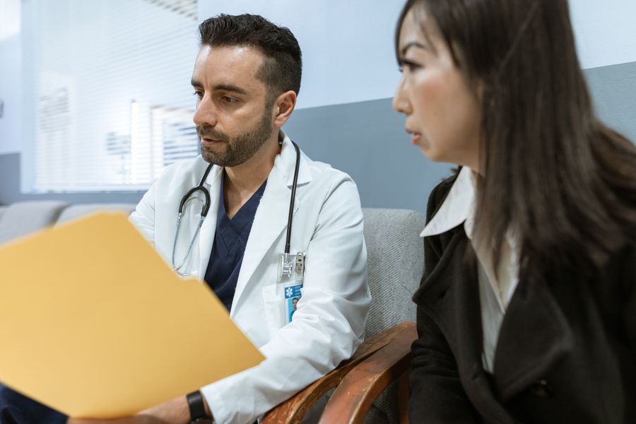 A doctor discussing health records with a patient in a clinical setting