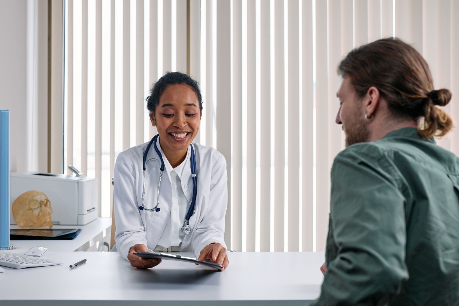 A doctor and patient in a positive consultation in a bright clinic room