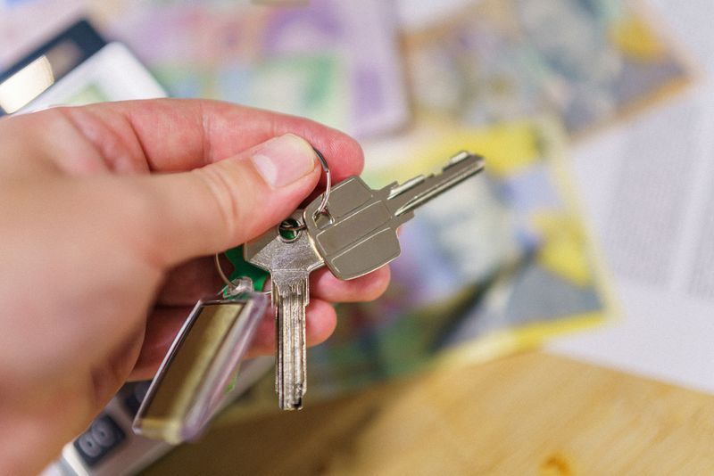 A keyring holding several house keys