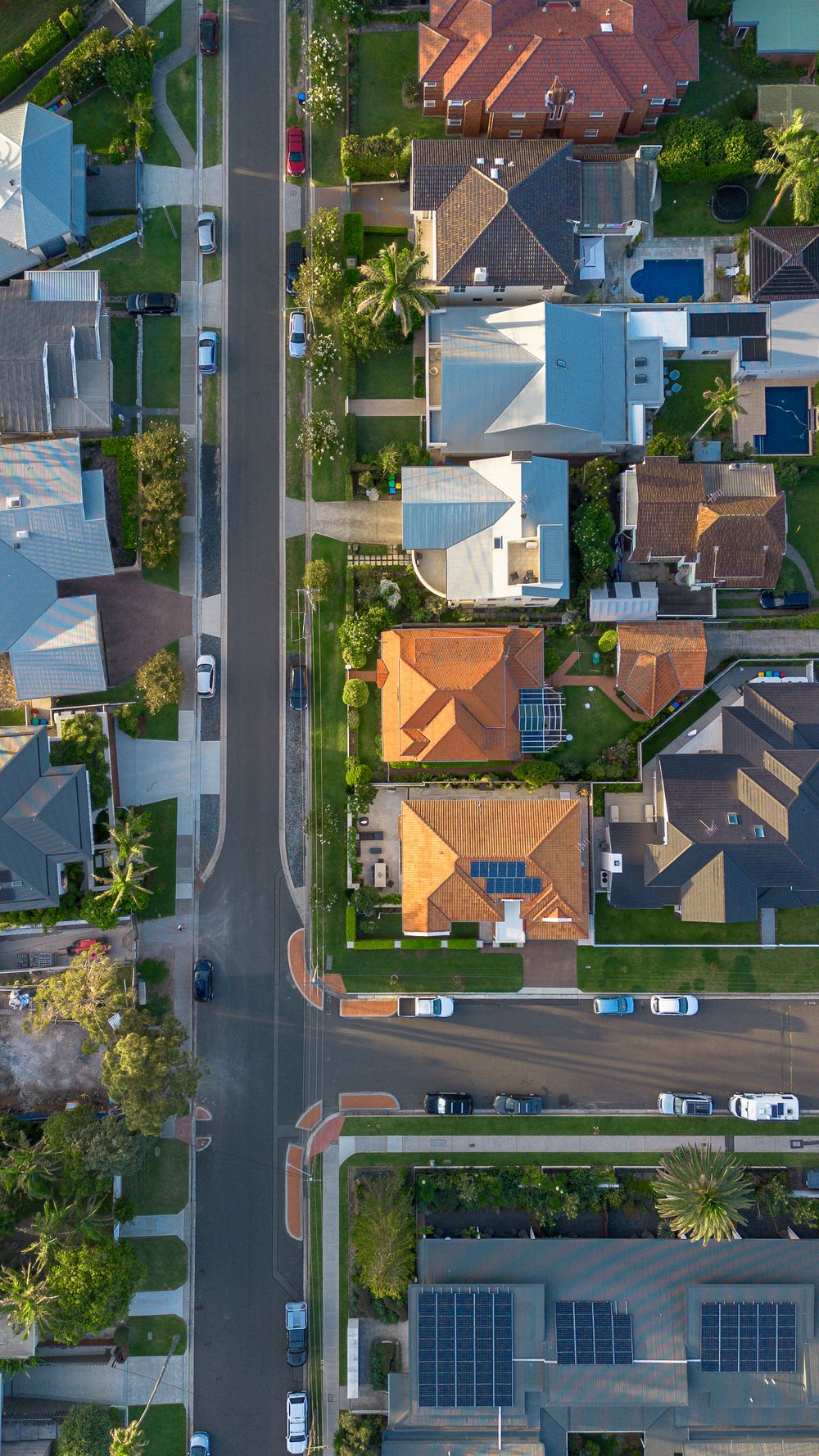 Aerial view of a suburban street of houses and gardens