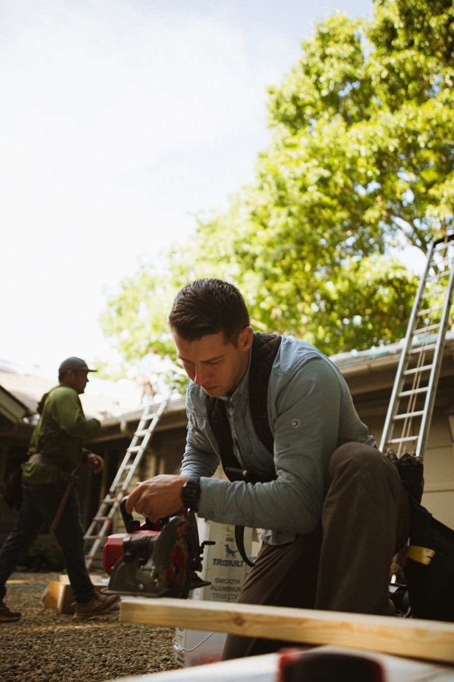 Construction workers with tools and ladders carrying out home improvement and carpentry work