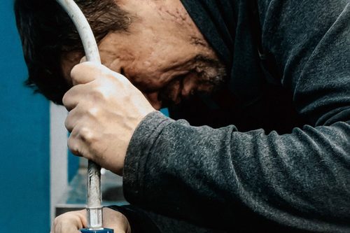 Plumber at work with hand tools