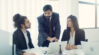 IT advisor presenting a strategy to a client in a meeting room