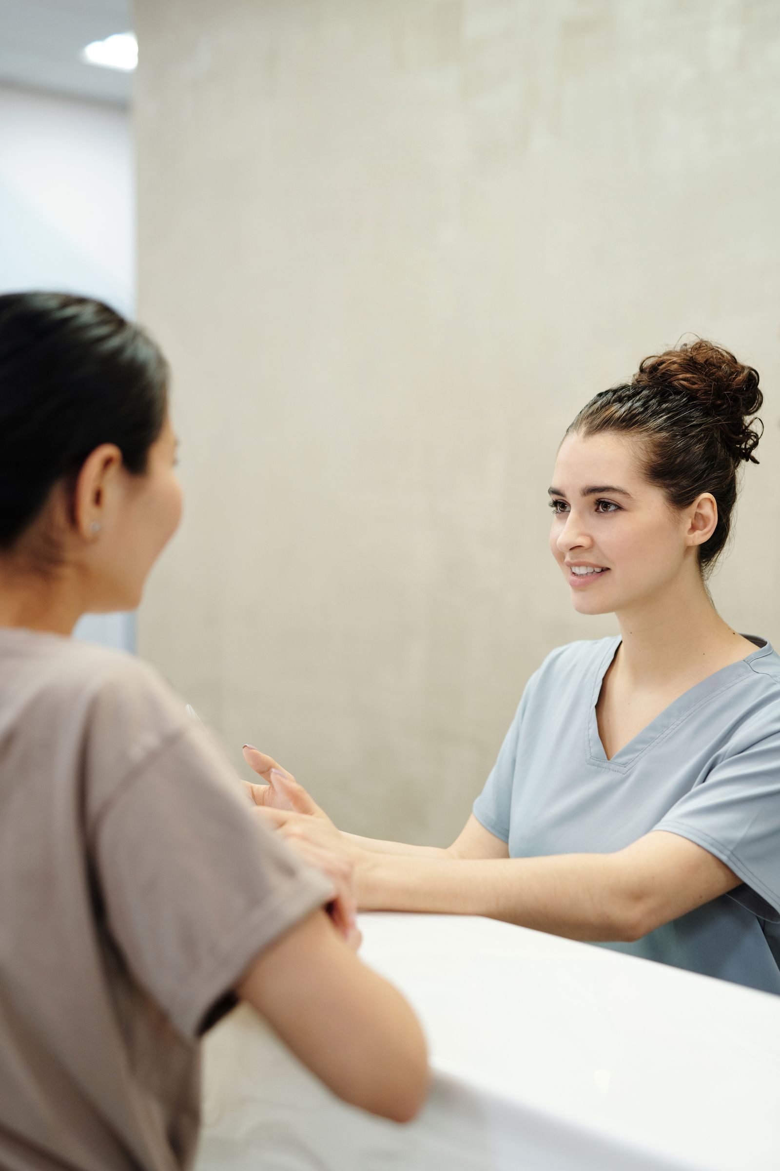 A clinician reviewing a patient's chart in a bright, welcoming consultation room